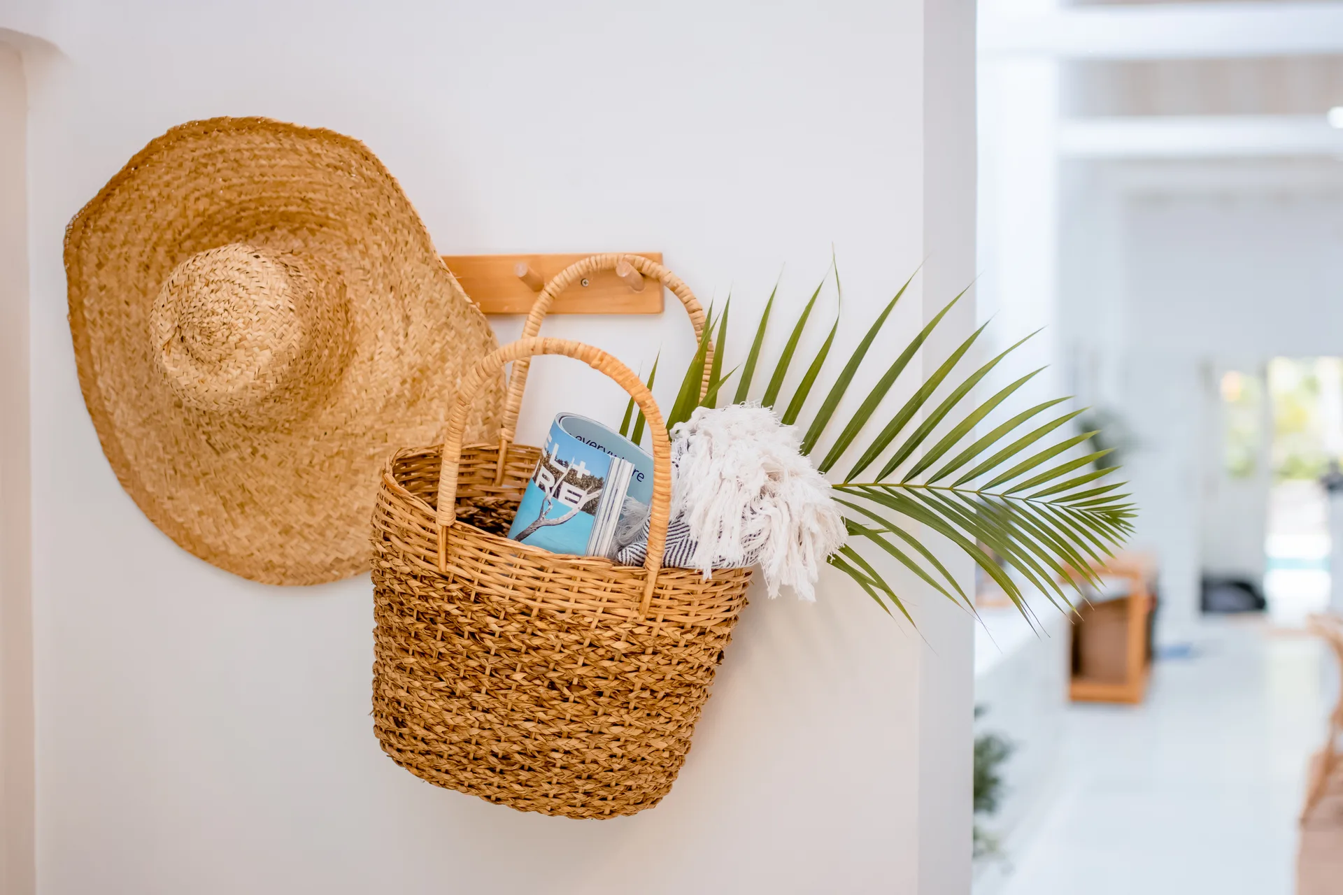 Beach basket and hat on villa wall hook - holiday amenities