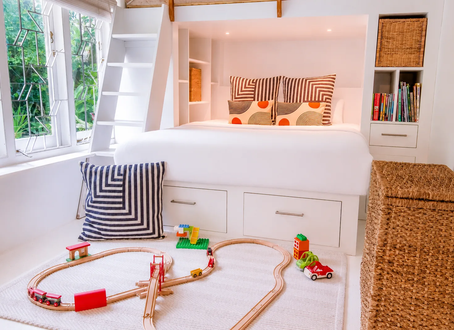 Children's room with custom bunk bed, train set and toy storage