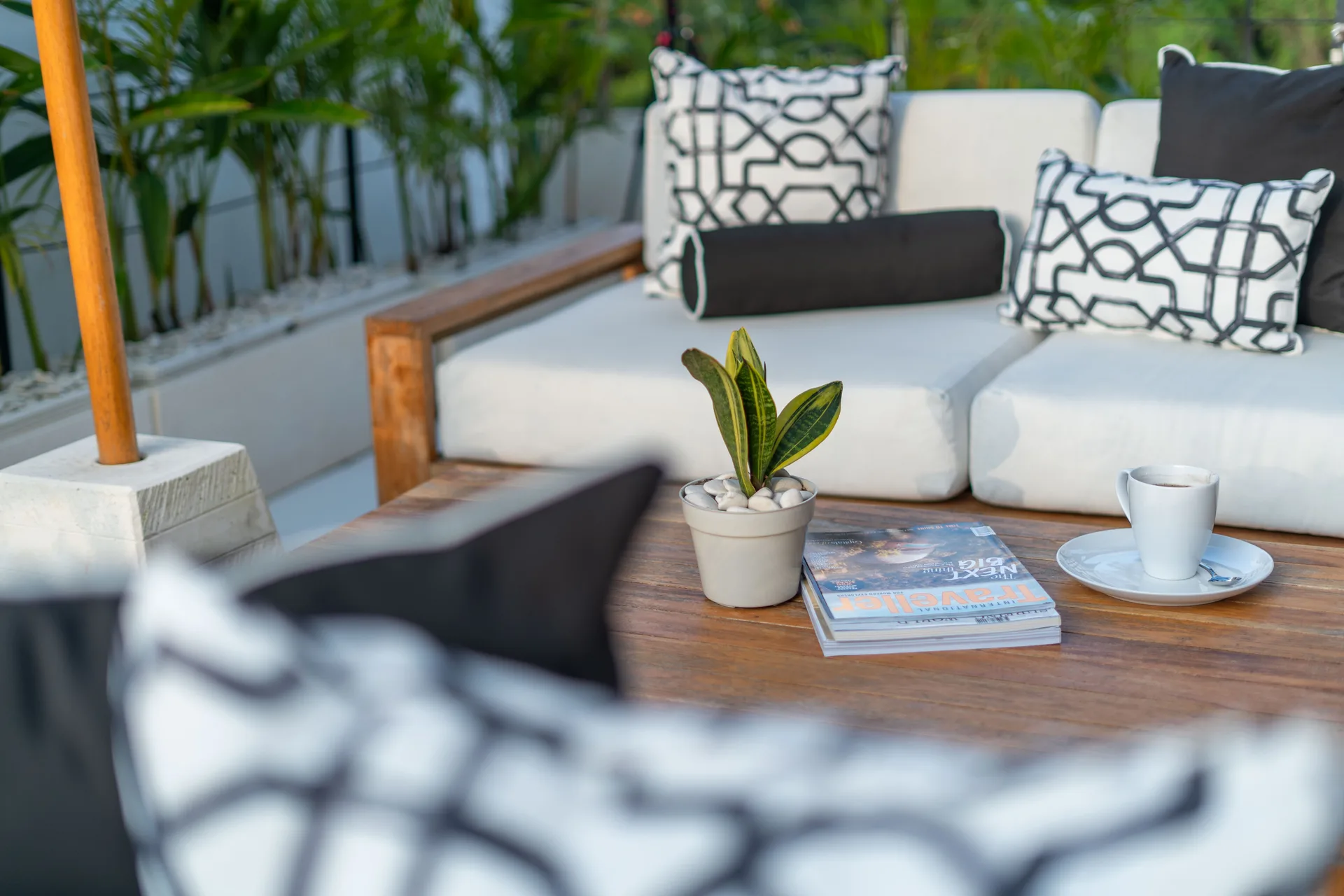 Outdoor lounge with custom teak sofa and tropical flowers